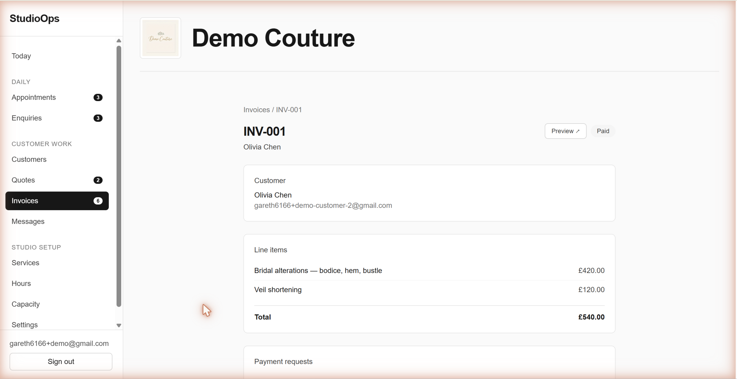 A fully paid invoice in StudioOps showing the deposit and balance both marked as settled by card via Square